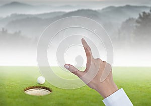 Womans Hand touching golf course mountains