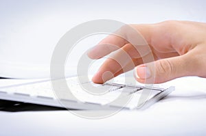 Womans hand typing on computer keyboard