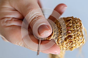 Womans hands with crochet hook and yarn. Handmade hobby concept