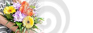 womans hands holding a beautiful bouquet of different flowers. Isolated on a white background. womens day web border or