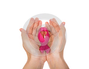 Womans hands holding pink breast cancer awareness ribbon isolate