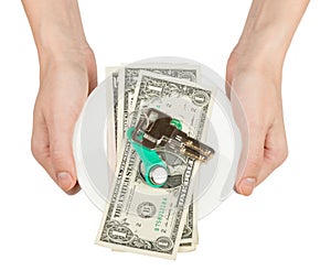 Womans hands holding saucer with cash and keys