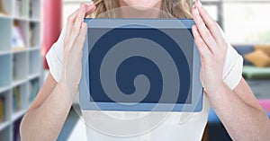 Womans hands holding tablet in Library