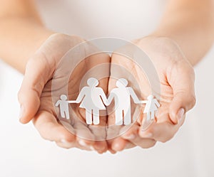 Womans hands with paper man family