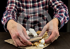 Womans Hands Reach Out to Pick up a Smore