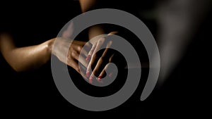 Womans hands with red nail polish, lady standing near bar counter in night club