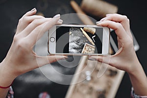 Womans hands taking picture of baking items