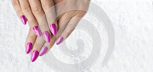 Womans hands with trendy pink with glitter french manicure
