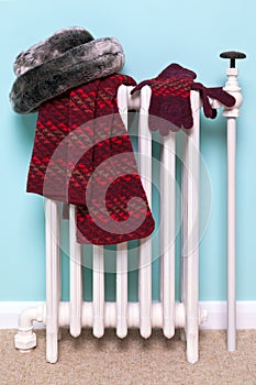 Womans hat scarf and gloves drying on a radiator