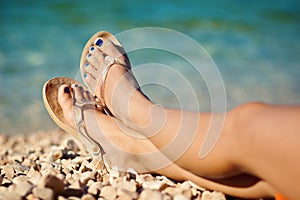 Womans legs at beach in summer