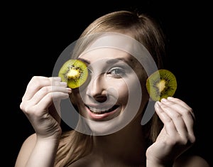 Womans mouth with slice of kiwi