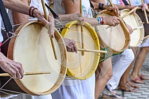 Womans percussionists playing drums during folk samba performance