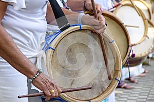 Womans percussionists playing drums during folk samba performance o