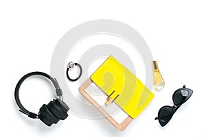 Womans set accessories Yellow, beige handbag, wireless headphones, perfume, scrunchy, black sunglasses isolated on white