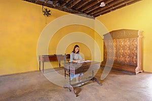 Womans signing a guest book with a pen