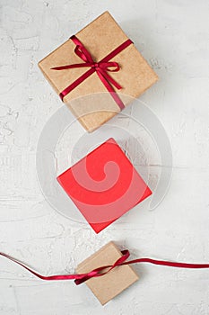 Womanâ€™s hands knotted red bow on the gift box