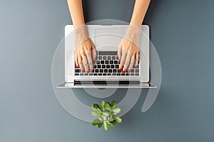 Womanâ€™s hands working on laptop. Business background.