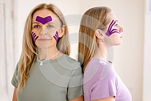 women 30 -40 years old with kinesio tape on face. Kinesiotaping for face,rejuvenation