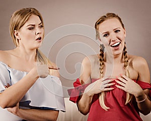 Women accusing each other of something