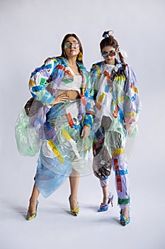 Women addicted of sales and clothes, wearing plastic, recycling concept