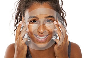 women applying concealer