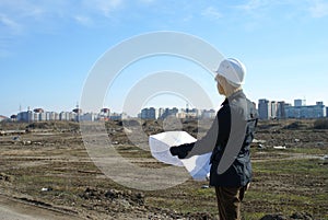 Women architect with hard hat at construction site