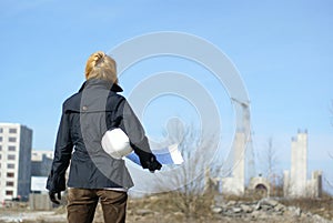 Women architect with hard hat at construction site