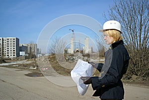 Women architect with hard hat at construction site