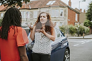 Women arguing after a car accident photo