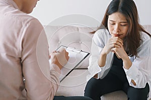 Women Asian patients with man psychologist examination consulting and In psychotherapy by the physician in the clinic.