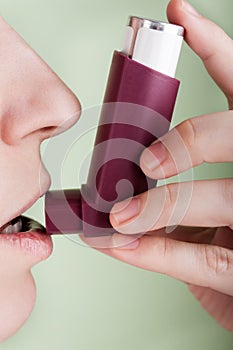 Women with asthmatic inhaler photo