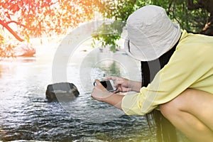 Women back or rare view sitting shooting photo via smartphone