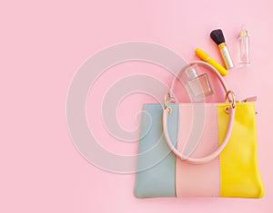 Women bag, cosmetics mascara  shopping   glamour    on a colored background