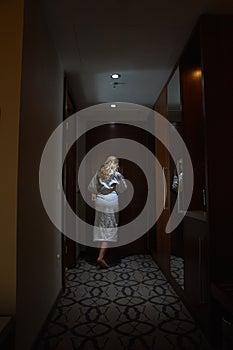 Women with Bathrobe looking through the Peephole