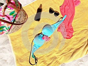 Women beachwear bikini  sunglasses dress and bag on yellow blanket at beach  sand