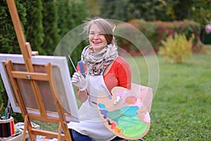 Women beautiful painter posing and smiling, laughing into camera