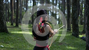 A Women with black dress getting ready with an arrow for cathing some a deer