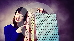 Women in blue dress with shopping bags