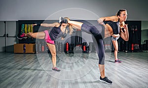 Women in a boxing class training high kick