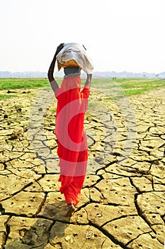 Women carrying baskets on dry ground