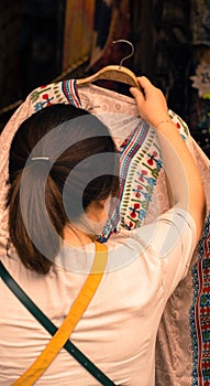 Women check shirt before shopping at jatujak market bangkok thailand