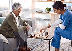 Women, chess and nurse with a senior patient, retirement home and happiness with healthcare. Female person, medical