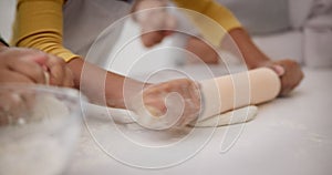 Women, child and hands rolling dough in kitchen for cookies, teaching and learning together with family in home. Mother