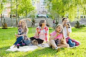 Women with children at sunset resting in the park, picnic, soap bubbles.