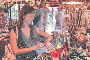 Women choosing bijouterie in the store. Bali island. Woman hands.