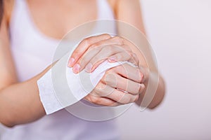 Women cleaning hands with wet wipes