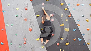 Women climbing on a wall in an outdoor climbing center.