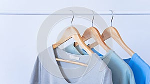 Women clothes hanging on wooden hangers in the store