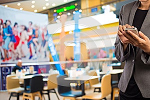 Women in Coffee shop using mobile phone