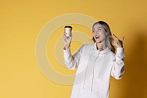 Women with coffee on yellow background